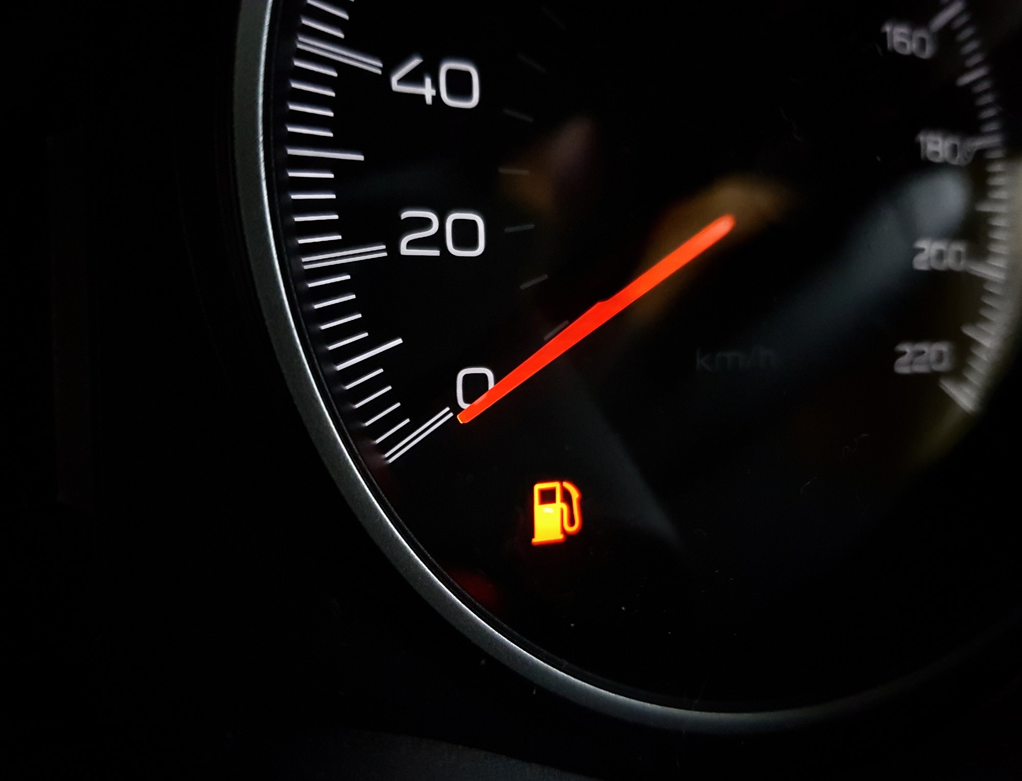 Orange low fuel indicator on a car dash